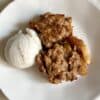 A serving of apple nut crumble with vanilla ice cream